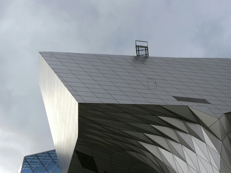 a grey building with a tower and window on top of it