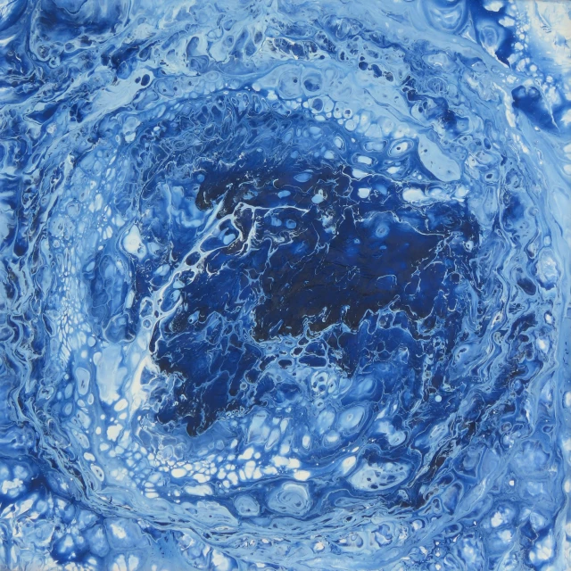 an abstract blue swirl pattern that has water droplets
