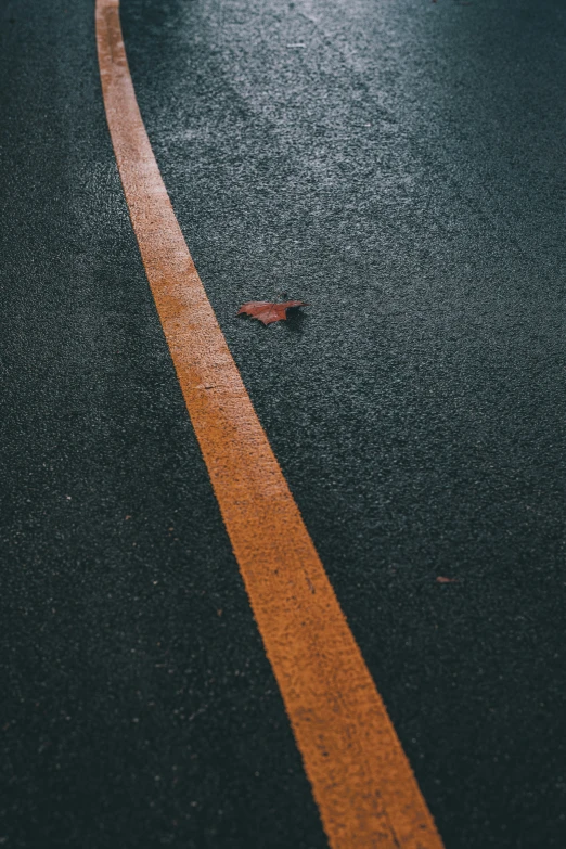 an empty street with an orange line painted on it