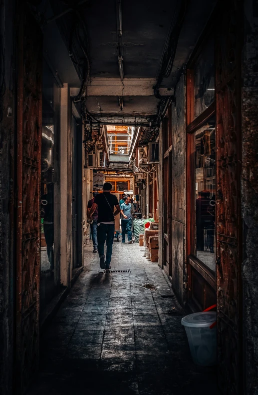 people walking along an alley that is very dirty