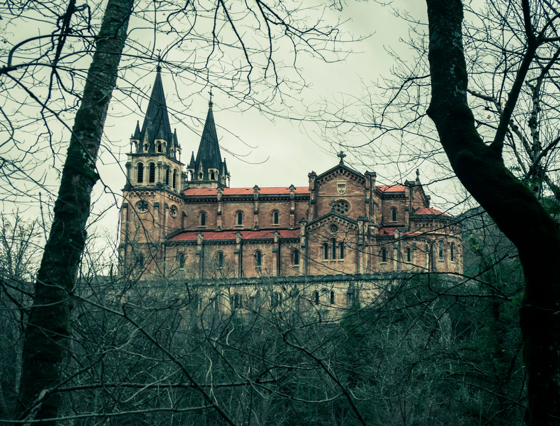 an old looking building sitting on top of a hill