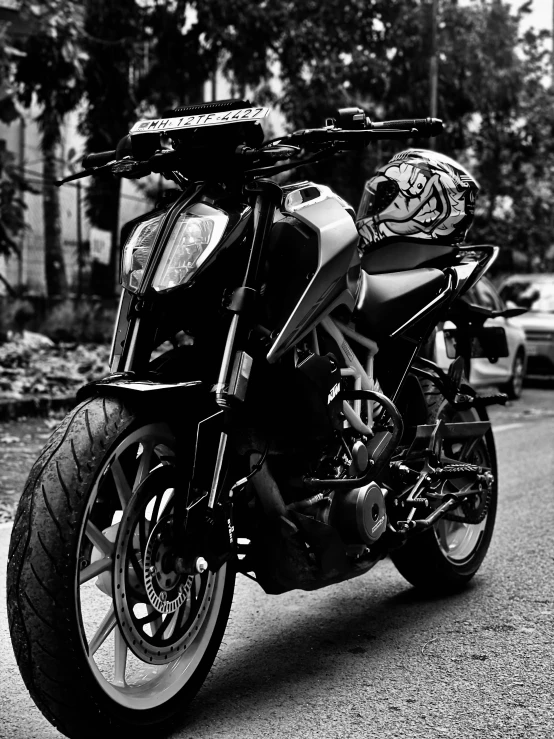 black and white po of motorcycle on side walk