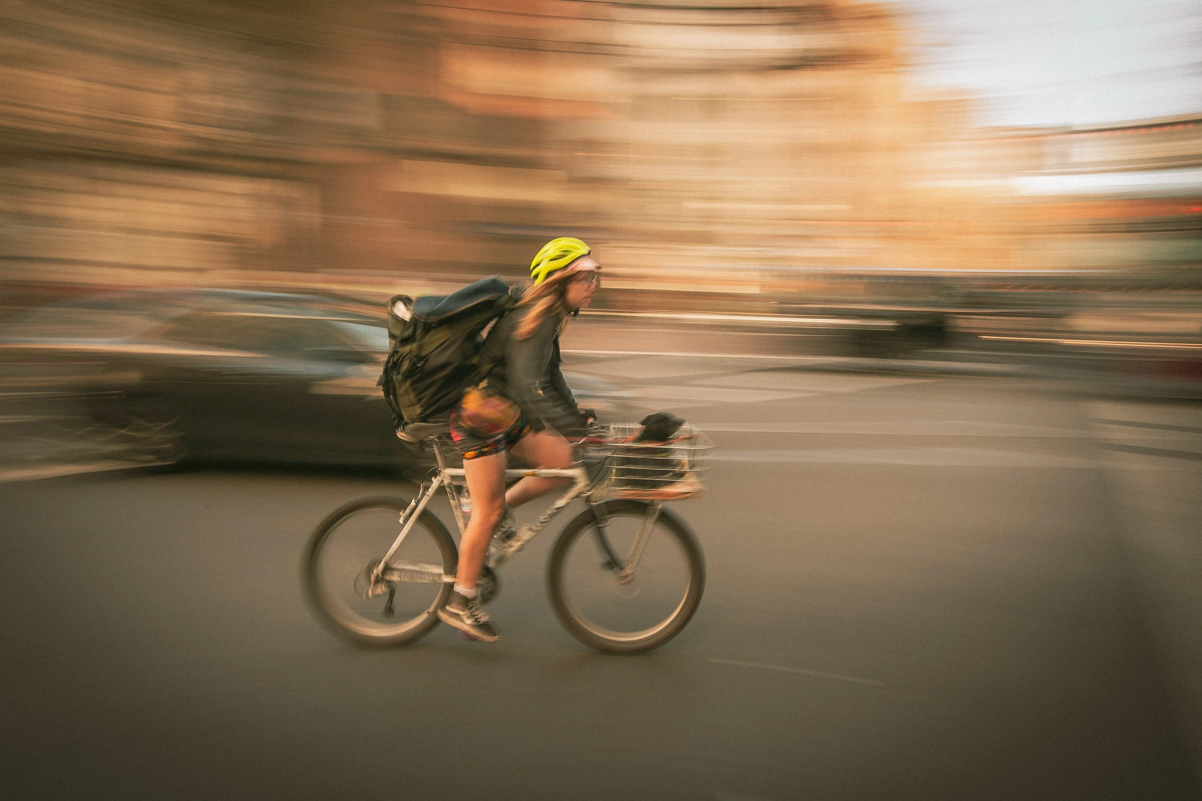 the woman rides her bike down the street