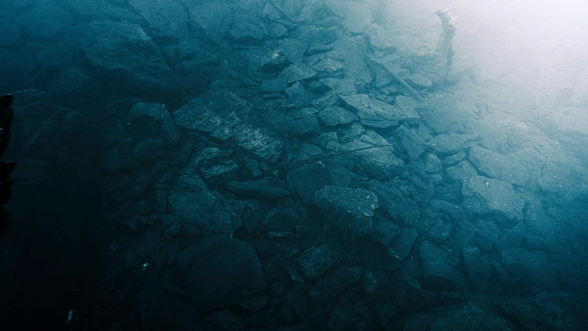 an open ocean with rocky shore lines at the top