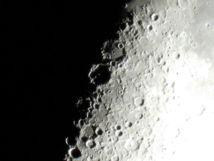 a view of the surface of the moon in a black background