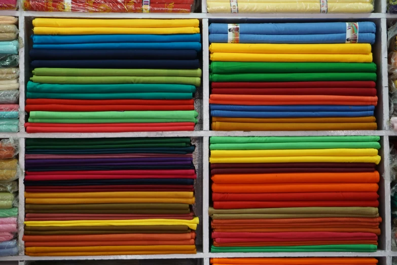 a rack with hundreds of different colored shirts