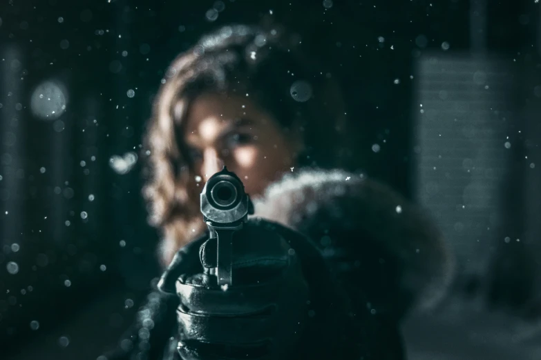 a person with a gun on top of snow