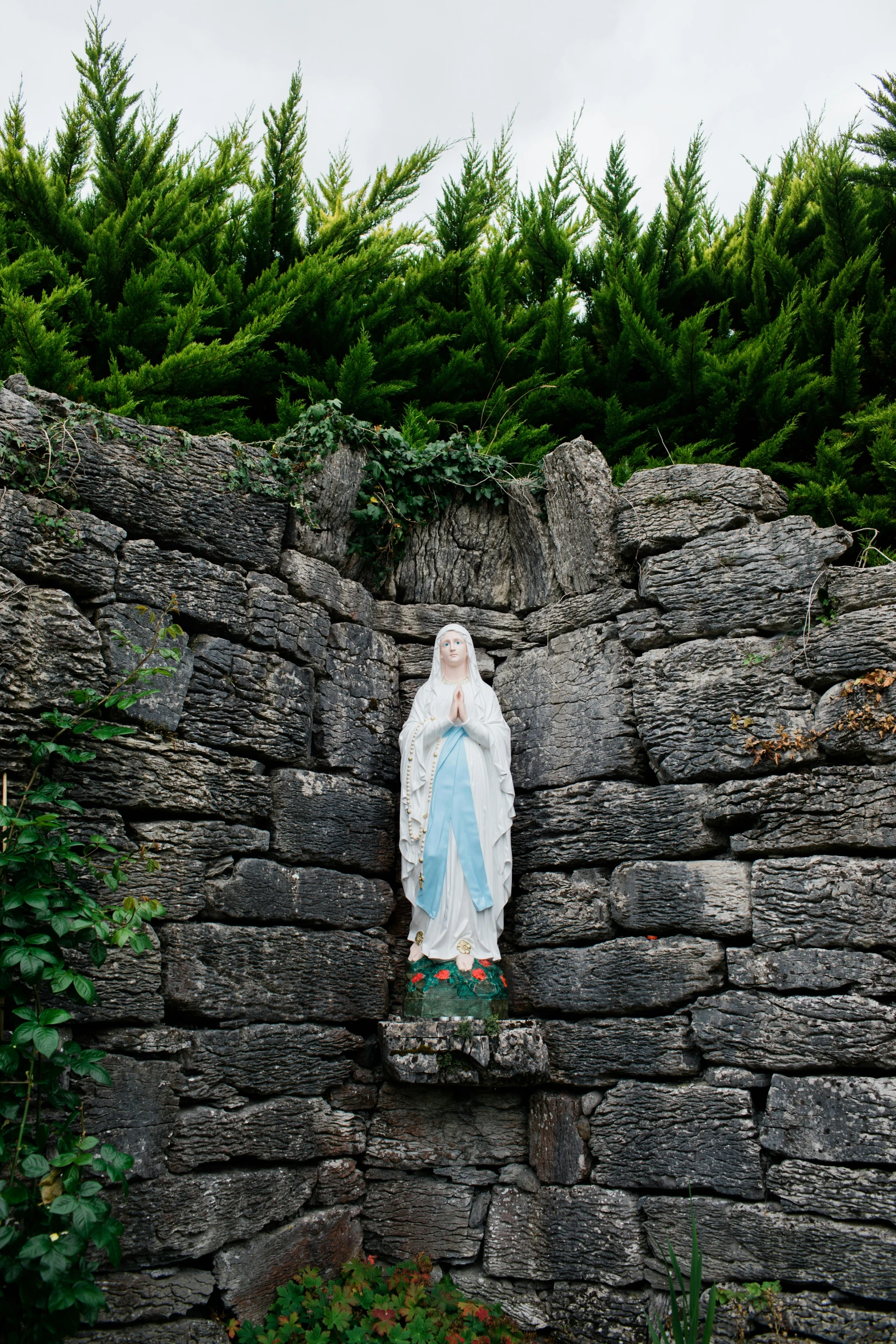 a stone walled area with an image of a person in the background