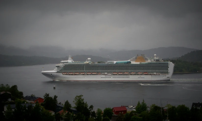 a cruise ship near some very mountainous hills