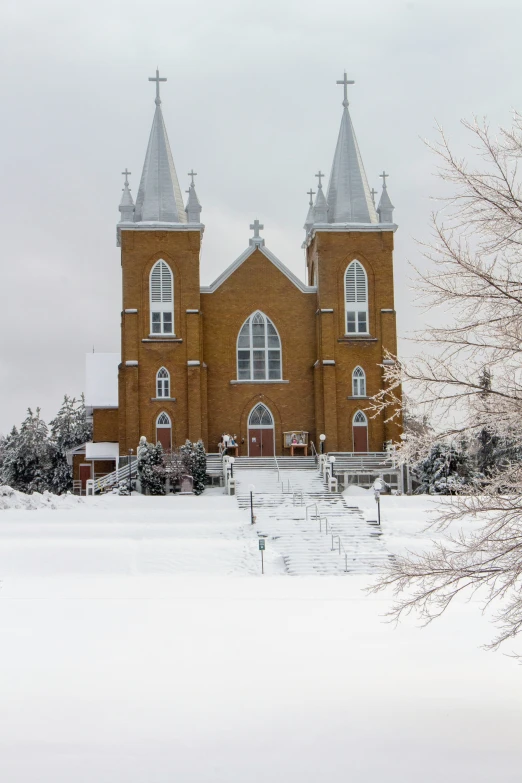 a large church with three towers and a snow covered ground