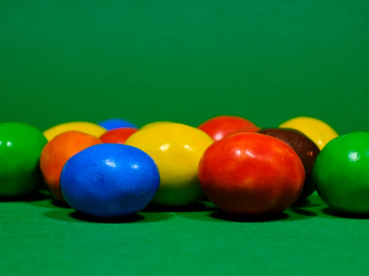 a green table with colorful balls on top