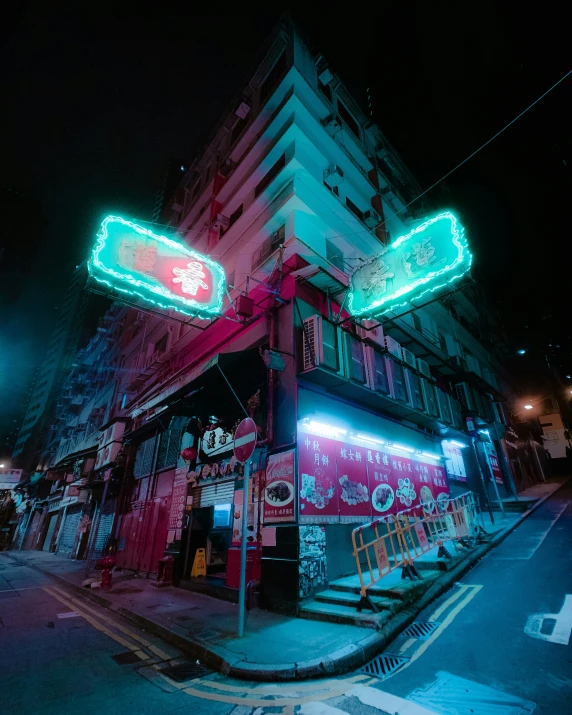 two colorful neon signs glowing up the side of a building