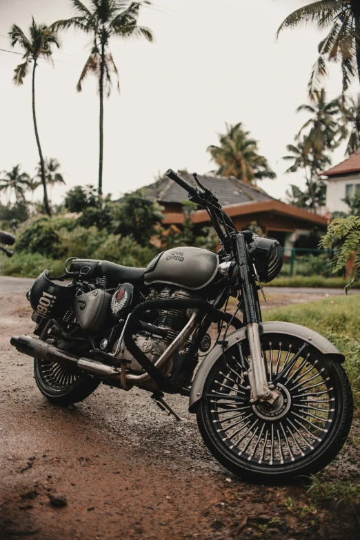 a motorcycle parked on top of a dirt road