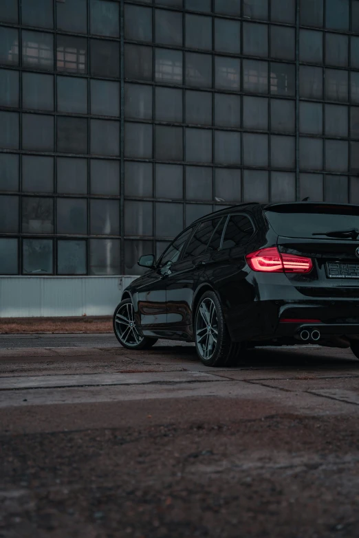 a bmw car sits parked in front of a building