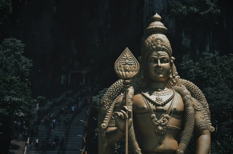 a statue of an indian god near some stairs