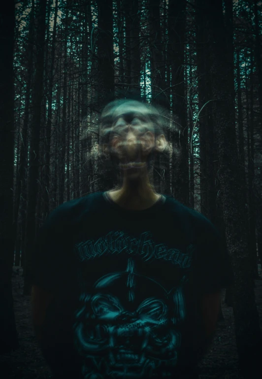 the man in the forest is wearing a blury shirt