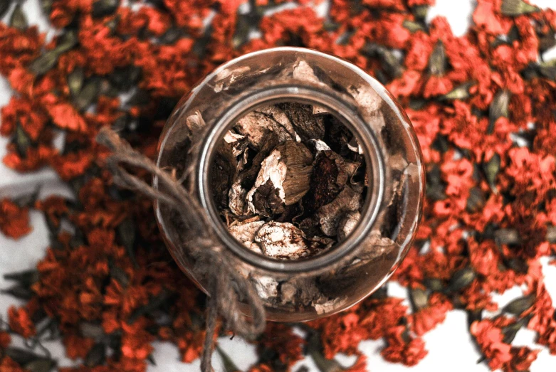 red flowers are in an old looking glass cup