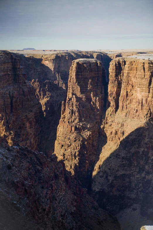 the sun is shining down on the cliffs of a mountain