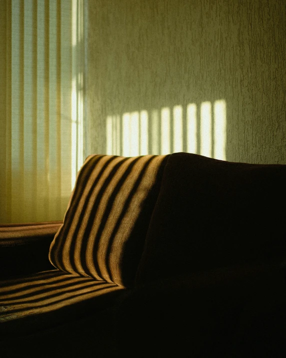 a light shines through a curtain on a bed