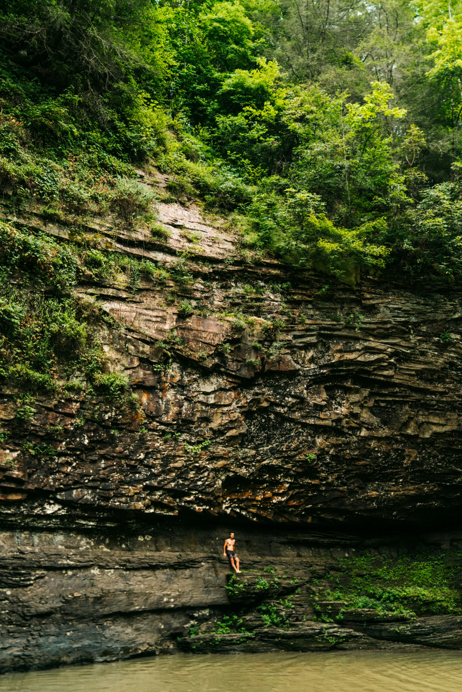 man standing in river looking out to his left