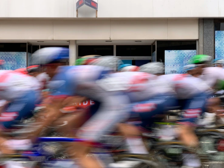 blurred pograph of a bunch of people riding bikes