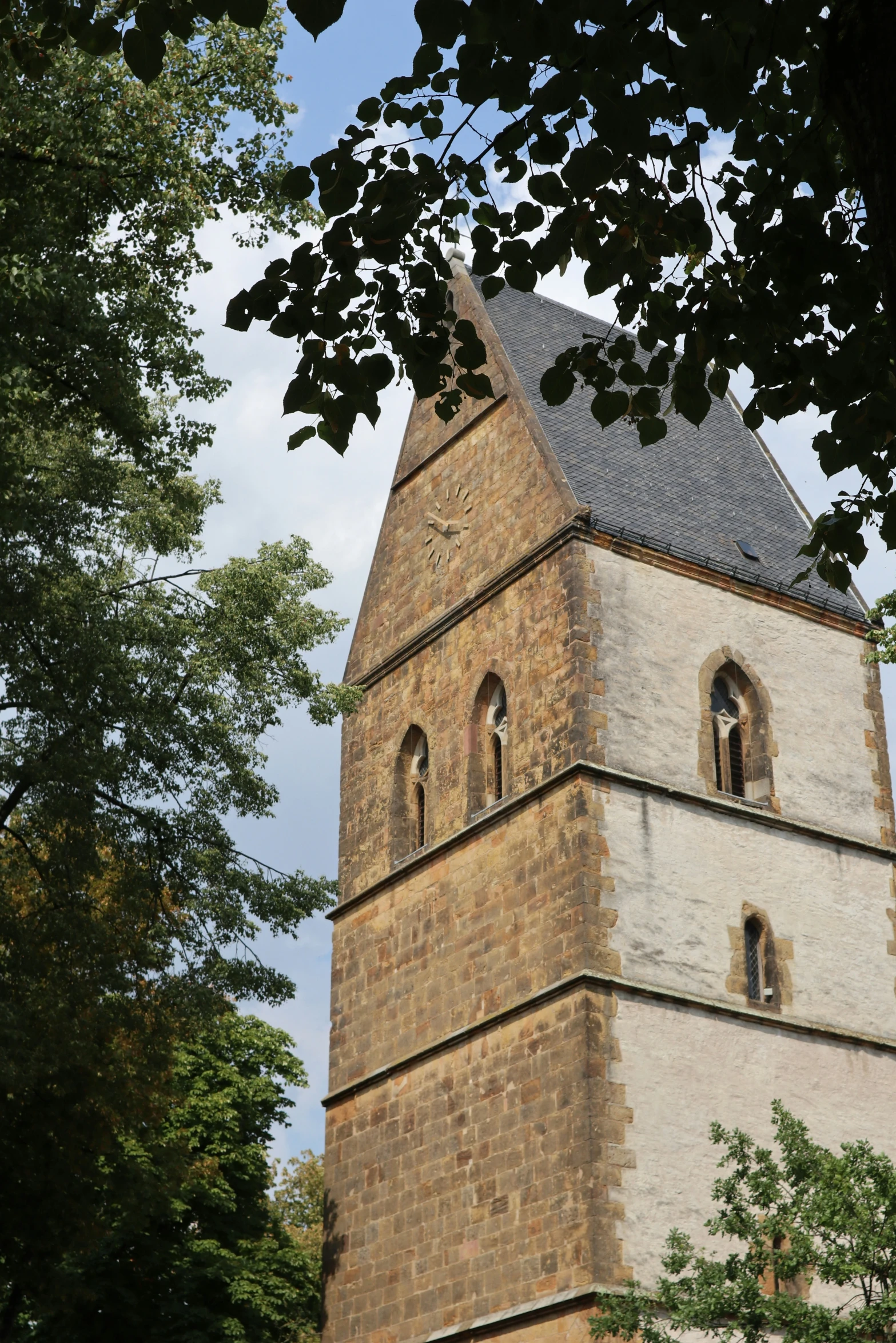 an old brick tower with a cross above it