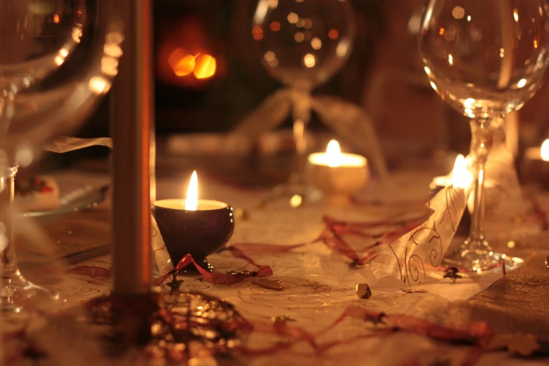 a candle on top of a table with place settings