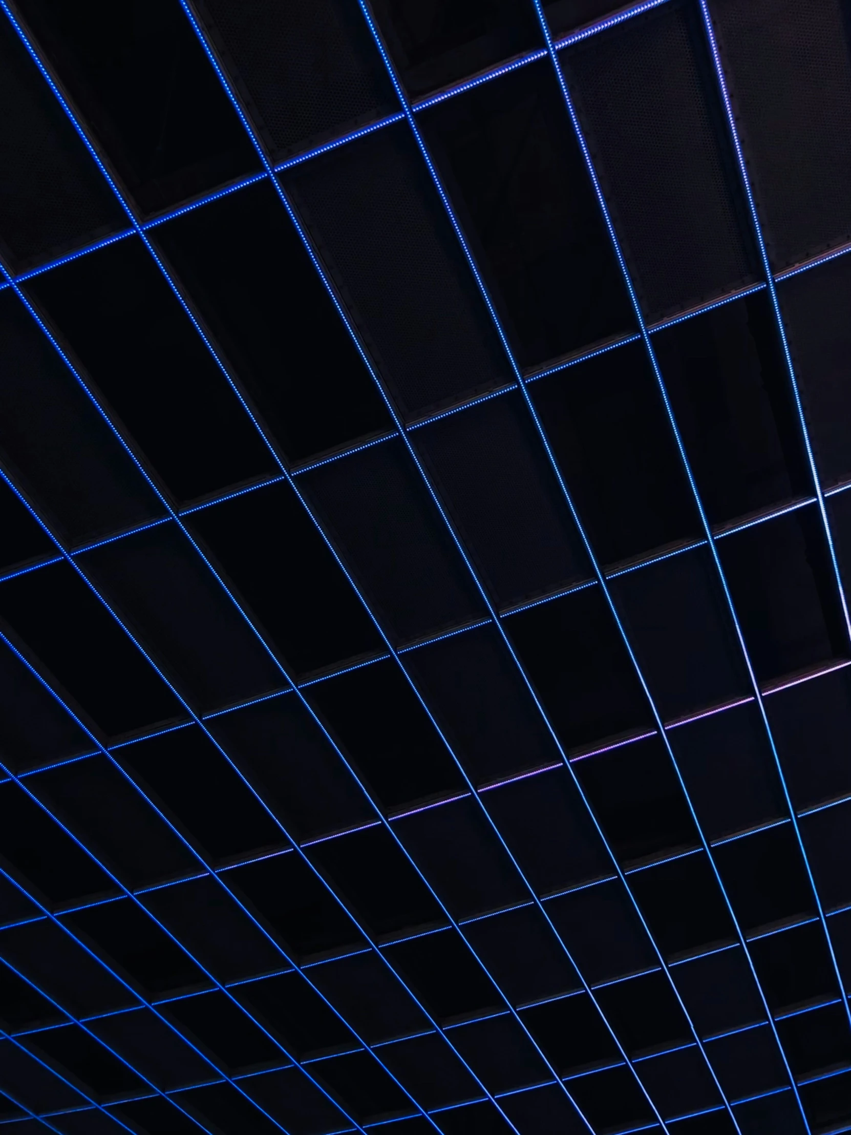 ceiling covering lit up at night by blue lights