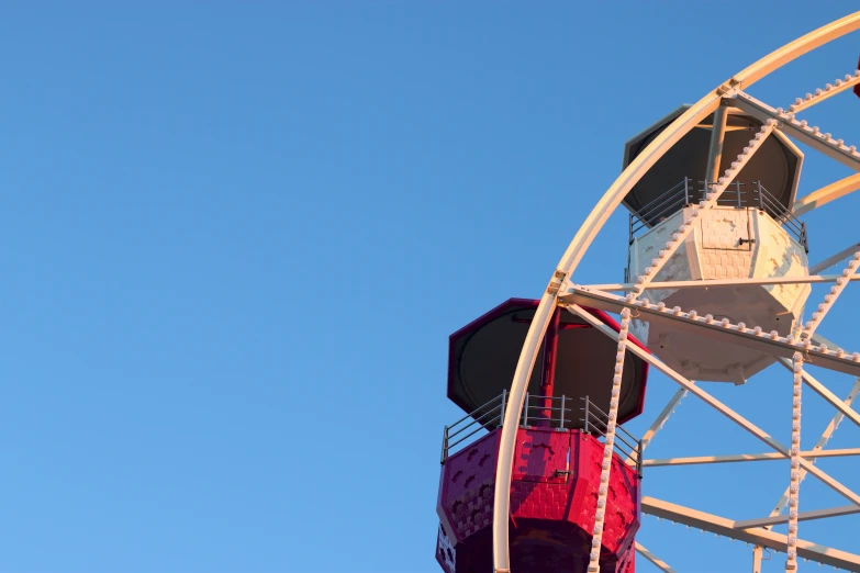 a clock tower with a large ferris wheel on it