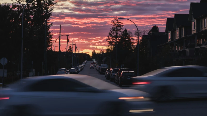 a group of cars on the road with a sky background