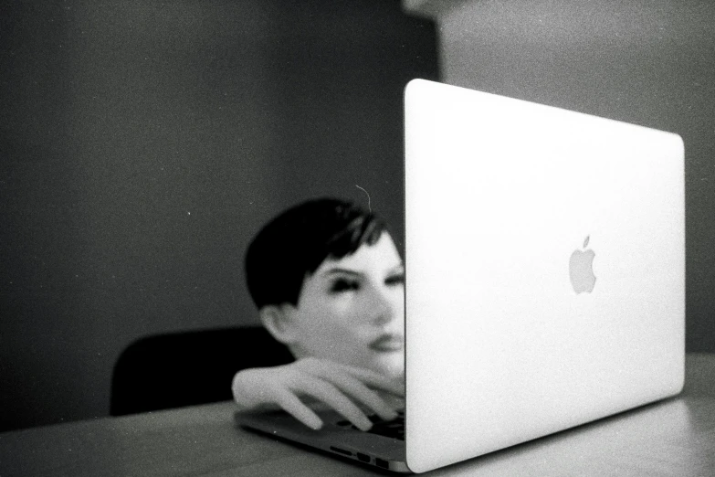 a laptop with an apple logo sits on a table