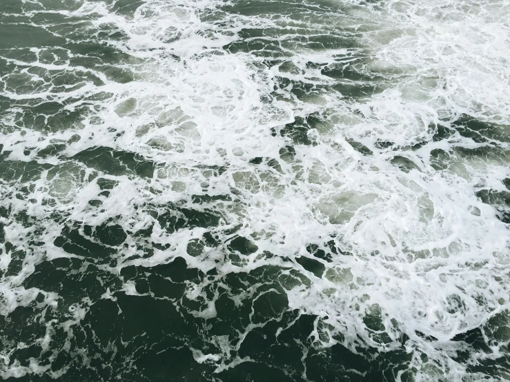 a view from a bird's eye view of waves crashing over the water