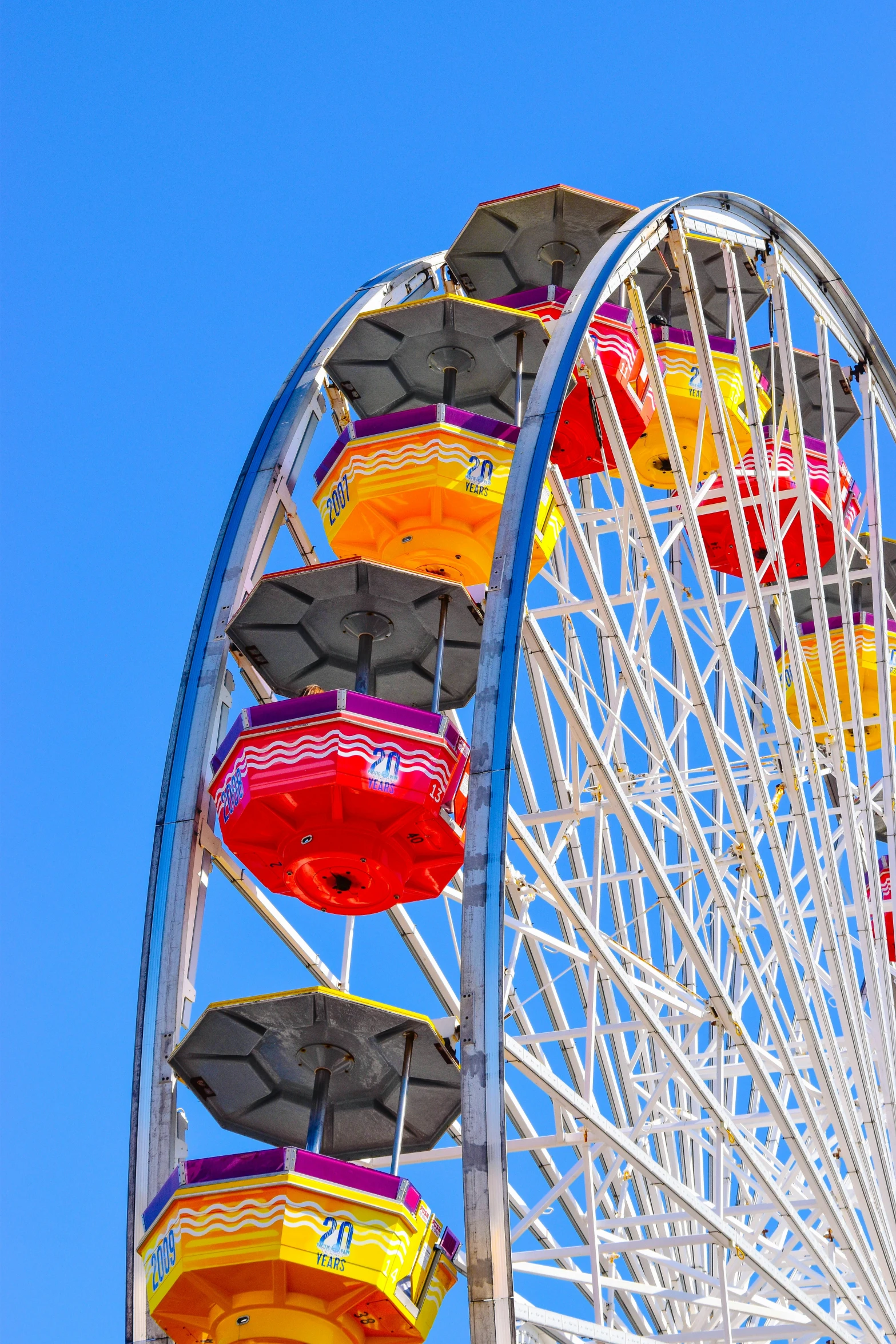 a colorful ferris wheel against a blue sky