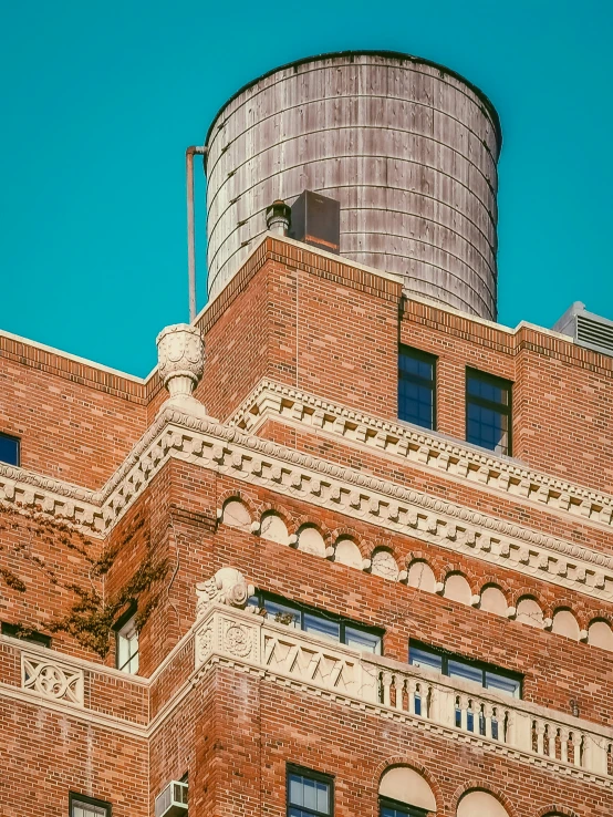 the top of a brick building that has many windows