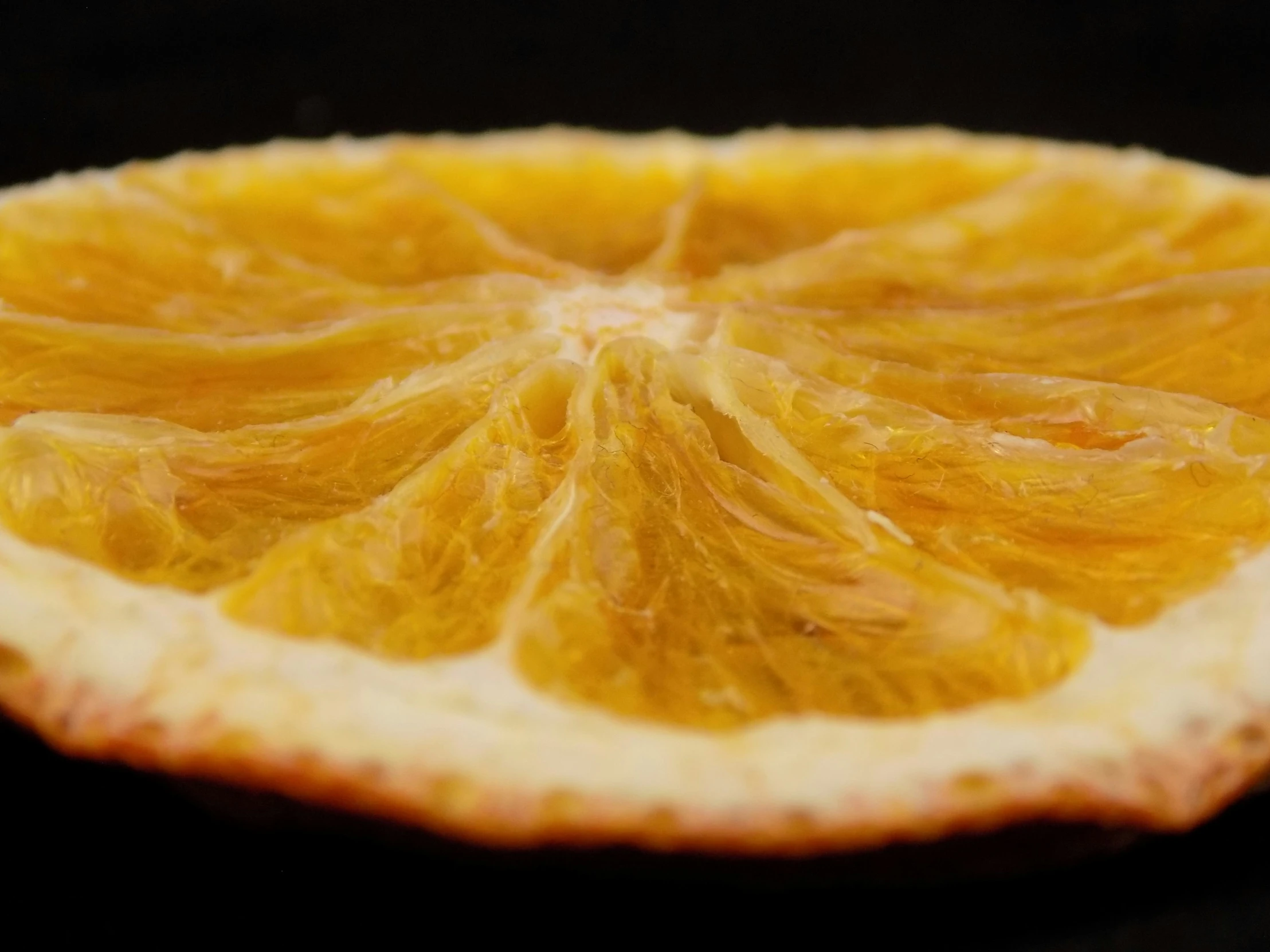 an orange sliced in half sitting on a table