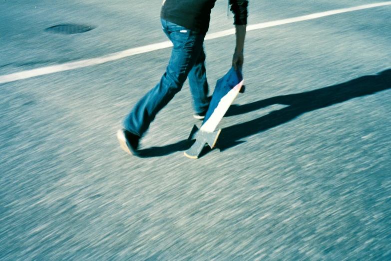 there is a person walking with a skateboard