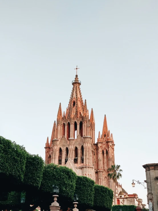 a building with tall spires on top and landscaping around it