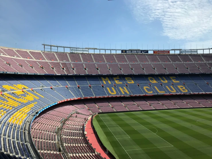 a sports stadium filled with people watching as a plane flies above