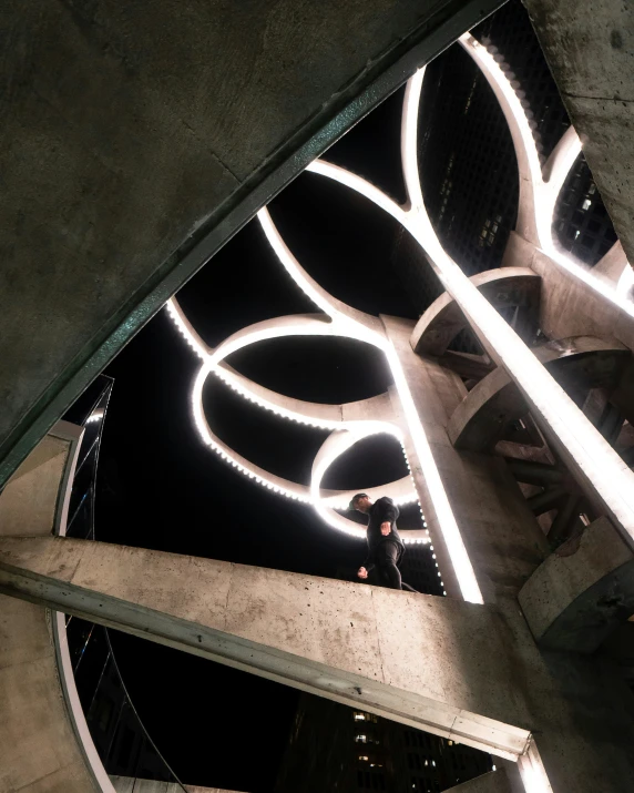 a view looking up at an illuminated clock and building