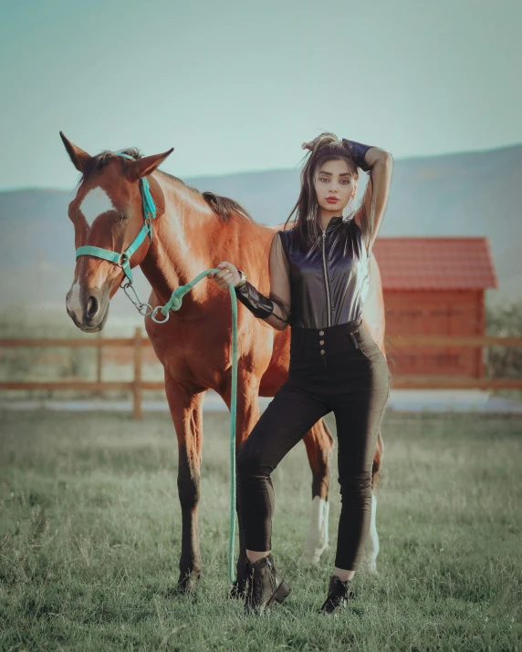 a young woman is holding the reins of her horse in front of a barn