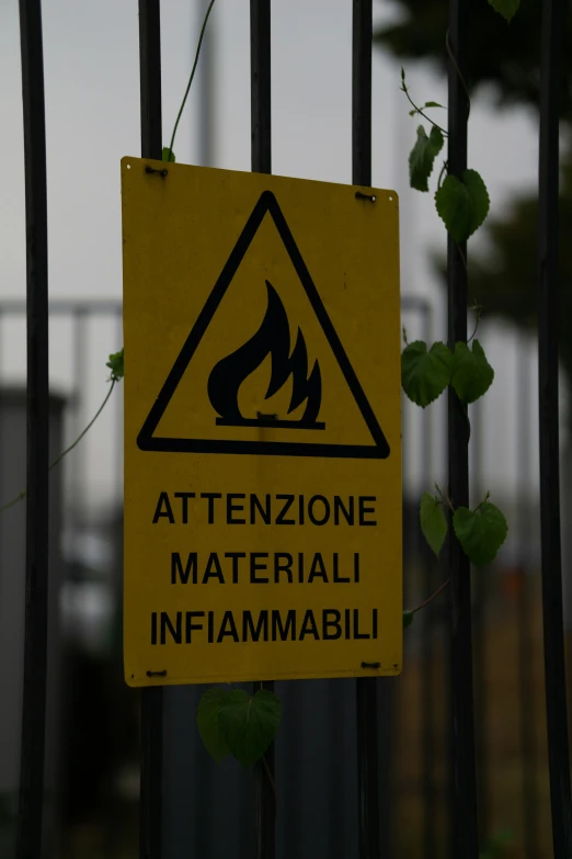 a yellow sign that has been placed on a gate