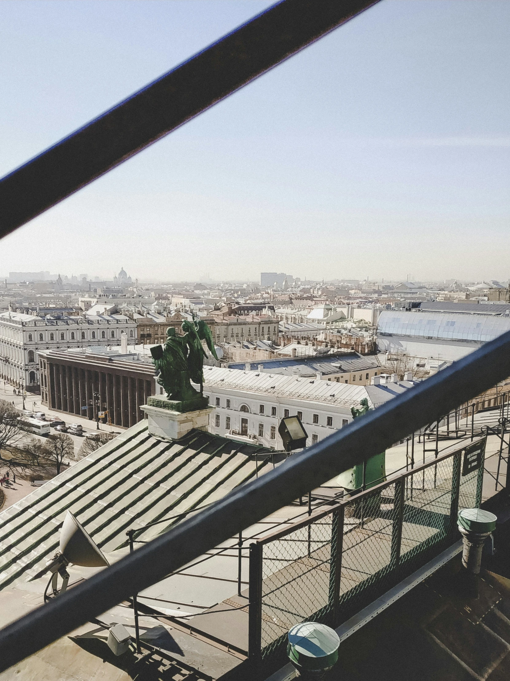 a balcony with railings and roofing next to a river