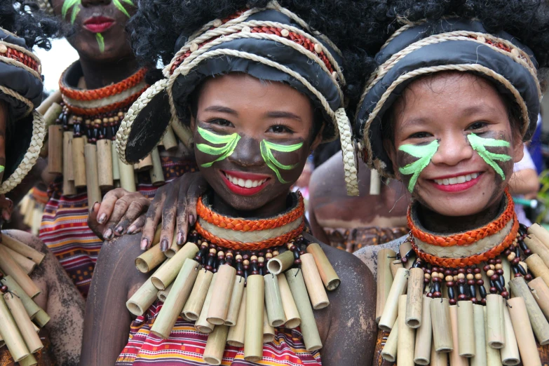 a group of women are covered in green paint