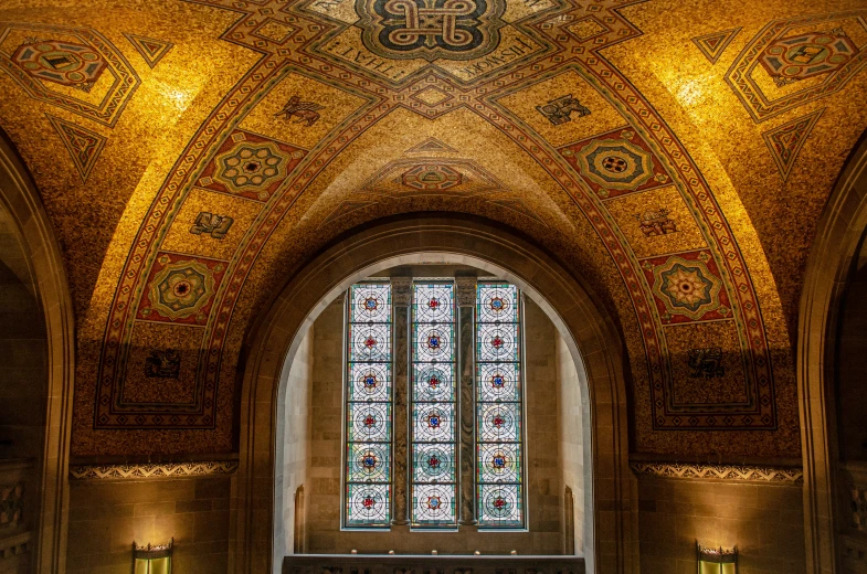 the inside of a church with many large stained glass windows