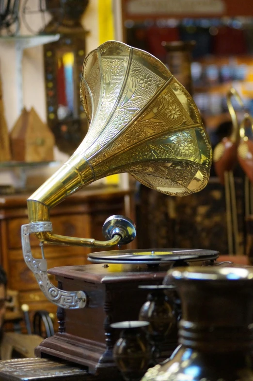 a golden, musical instrument sits on top of a desk