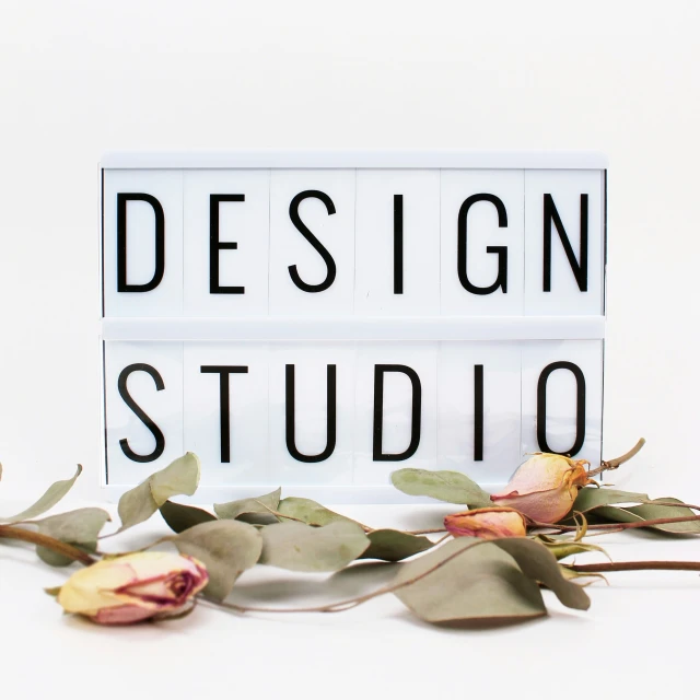 the word design studio written on a light box