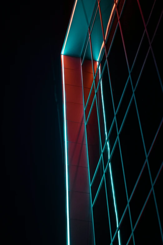 a view of the side of an office building, lit up at night