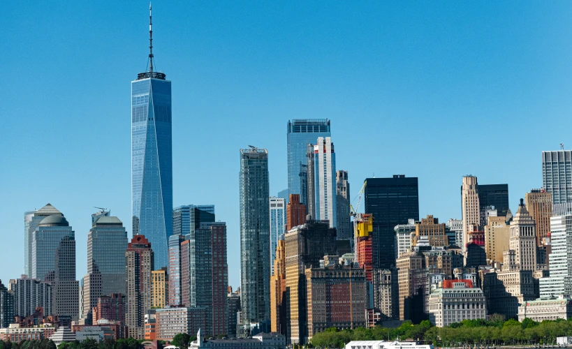 a boat sails past the large city skyline