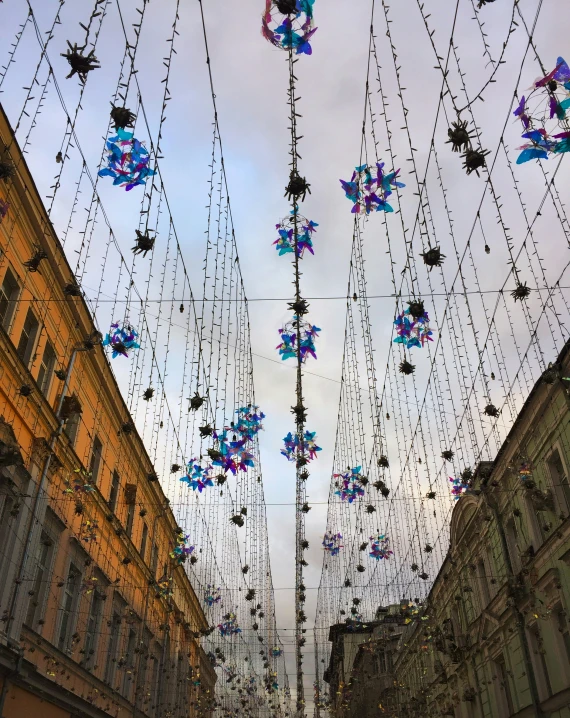 a street filled with lots of colorful decorations on top of buildings