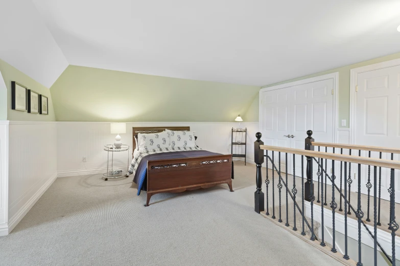 a large white bed sitting in the middle of a bedroom